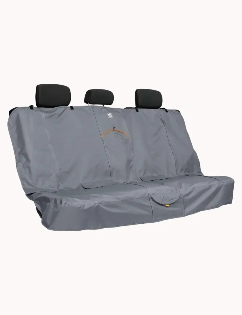 Kurgo waterproof bench seat cover installed in car back seat, shown in black